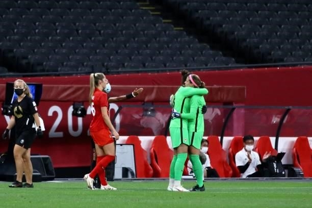 Stephanie Labbe of Team Canada is embraced by teammate Kailen Sheridan as she is substitutedduring the Women's First Round Group E match between...