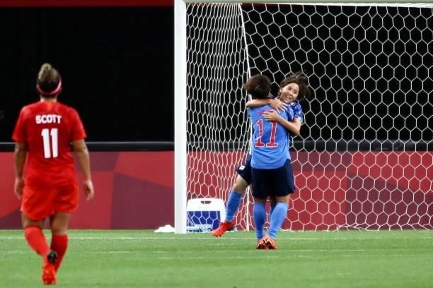 Mana Iwabuchi of Team Japan celebrates with teammate Mina Tanaka after scoring their side's first goal during the Women's First Round Group E match...