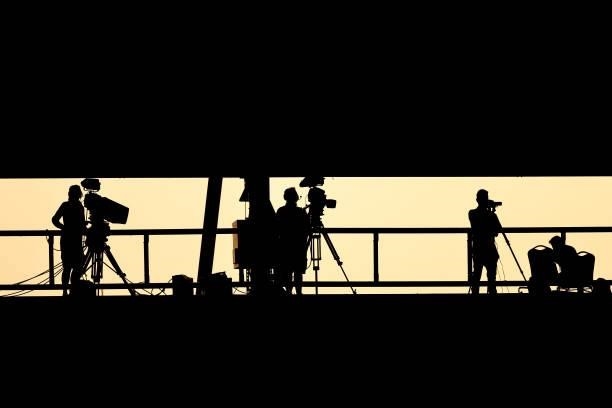 Silhouettes of TV camera crews during the pre-season friendly between Colchester United and Tottenham Hotspur at JobServe Community Stadium on July...