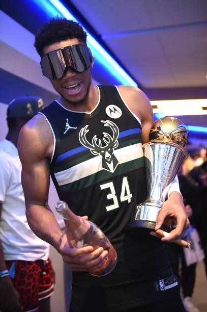 Giannis Antetokounmpo of the Milwaukee Bucks celebrates with the Larry O'Brien Trophy after winning Game Six of the 2021 NBA Finals on July 20, 2021...