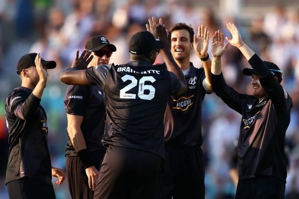 Steven Finn of the Manchester Originals celebrates with team mates after taking a wicket during The Hundred match between Oval Invincibles Men and...