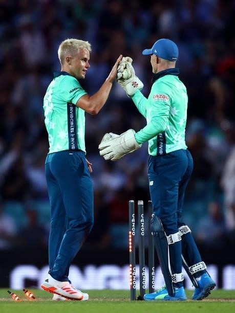 Sam Billings and Sam Curran of the Oval Invincibles celebrate their team's win during The Hundred match between Oval Invincibles Men and Manchester...
