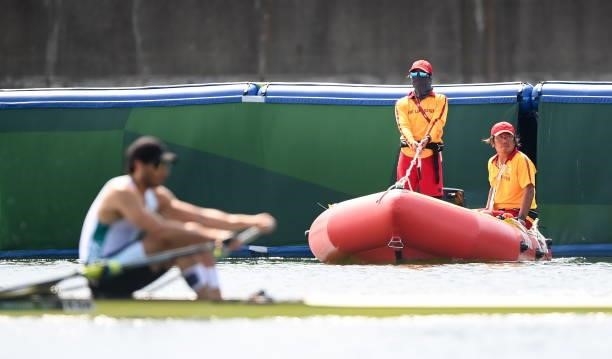 Tokyo , Japan - 23 July 2021; Members of the surf rescue team watch on during the heats of the men's single sculls event at the Sea Forest Waterway...