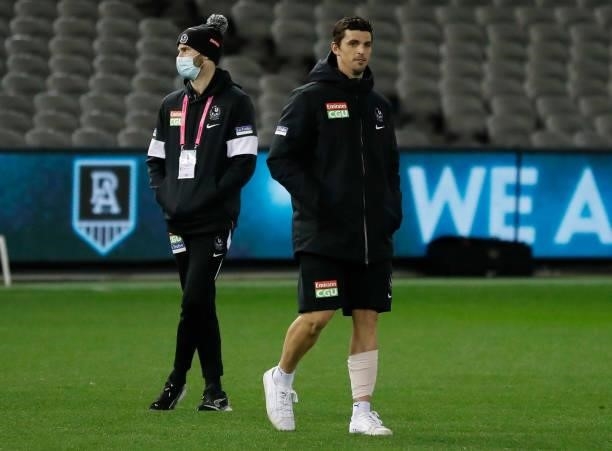 Scott Pendlebury of the Magpies looks on with a bandaged leg during the 2021 AFL Round 19 match between the Port Adelaide Power and the Collingwood...