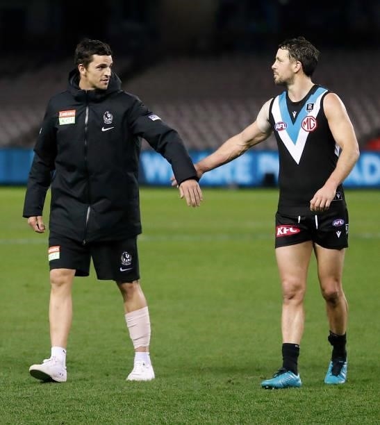 Scott Pendlebury of the Magpies congratulates Travis Boak of the Power after his 300th match during the 2021 AFL Round 19 match between the Port...