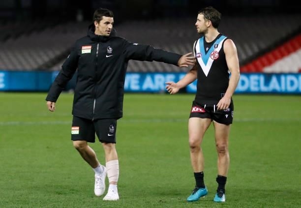 Scott Pendlebury of the Magpies congratulates Travis Boak of the Power after his 300th match during the 2021 AFL Round 19 match between the Port...