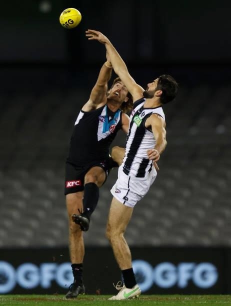Scott Lycett of the Power and Brodie Grundy of the Magpies compete in a ruck contest during the 2021 AFL Round 19 match between the Port Adelaide...