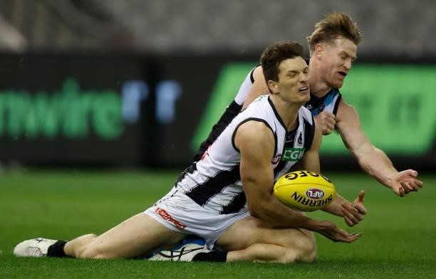 Brody Mihocek of the Magpies and Tom Jonas of the Power in action during the 2021 AFL Round 19 match between the Port Adelaide Power and the...