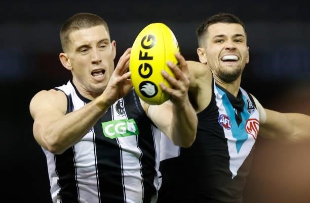 Darcy Cameron of the Magpies and Ryan Burton of the Power in action during the 2021 AFL Round 19 match between the Port Adelaide Power and the...
