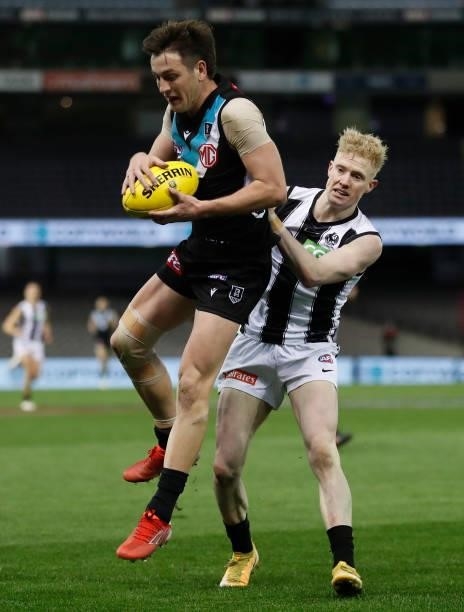 Zak Butters of the Power and John Noble of the Magpies in action during the 2021 AFL Round 19 match between the Port Adelaide Power and the...
