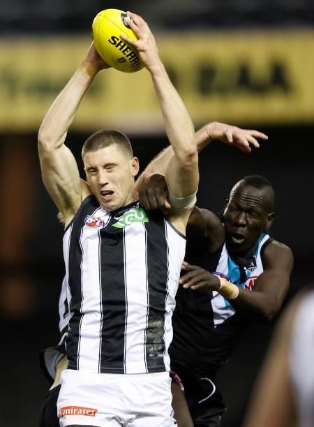Darcy Cameron of the Magpies and Aliir Aliir of the Power compete for the ball during the 2021 AFL Round 19 match between the Port Adelaide Power and...