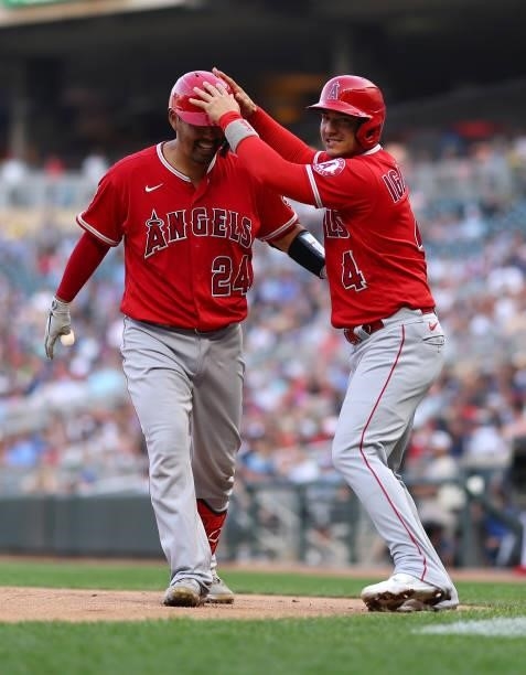 Kurt Suzuki and Jose Iglesias of the Los Angeles Angels celebrate a home run in the first inning against the Minnesota Twins at Target Field on July...