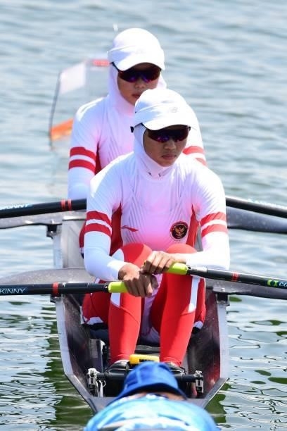 Indonesia's Mutiara Putri and Indonesia's Melani Putri compete in the lightweight women's double sculls heats during the Tokyo 2020 Olympic Games at...