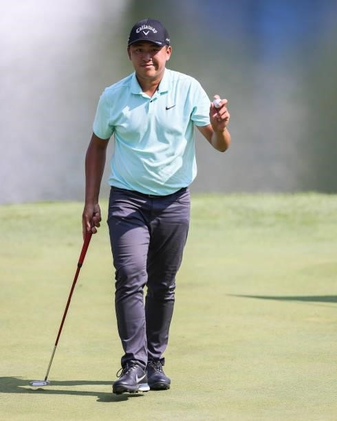 Kevin Yu of Chinese Taipei acknowledges the crowd after sinking his putt on the 9th green during the second round of the Price Cutter Charity...