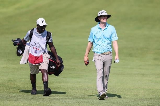Mark Baldwin walks with his caddie on the 9th hole during the second round of the Price Cutter Charity Championship presented by Dr. Pepper at...