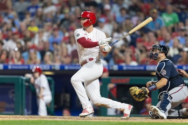 Rhys Hoskins of the Philadelphia Phillies hits an RBI double in the bottom of the seventh inning against the Atlanta Braves at Citizens Bank Park on...