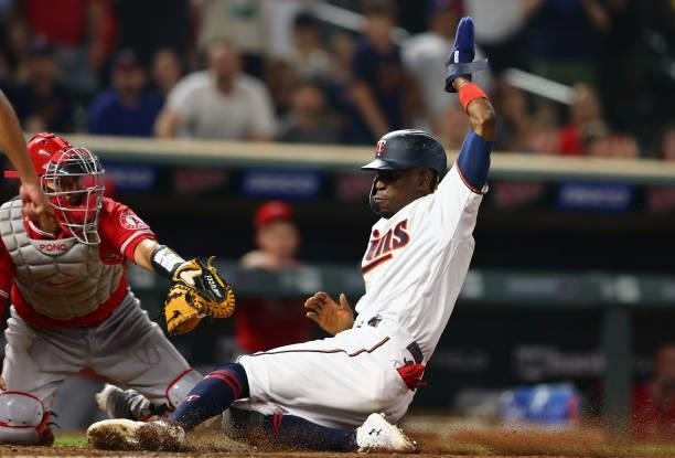 Nick Gordon of the Minnesota Twins slides safely into home base as Kurt Suzuki of the Los Angeles Angels attempts the tag unsuccessfully in the...