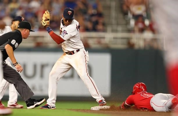 Jorge Polanco of the Minnesota Twins attempts to tag out Justin Upton of the Los Angeles Angels in the seventh inning at Target Field on July 23,...