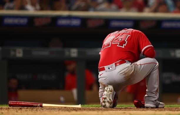 Kurt Suzuki of the Los Angeles Angels takes a knee after getting hit by a pitch in the seventh inning at Target Field on July 23, 2021 in...