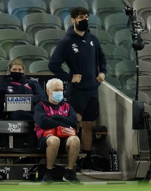 Zac Williams of the Blues looks on from the bench after being subbed out of the match during the 2021 AFL Round 19 match between the Carlton Blues...