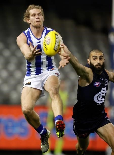Jed Anderson of the Kangaroos and Adam Saad of the Blues compete for the ball during the 2021 AFL Round 19 match between the Carlton Blues and the...