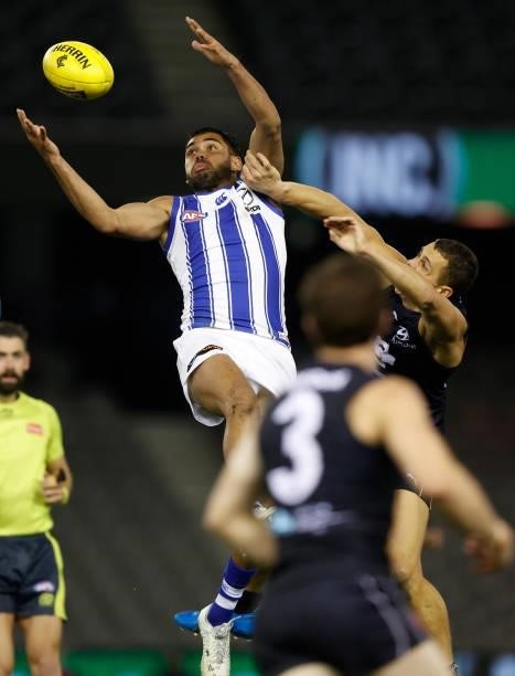 Tarryn Thomas of the Kangaroos and Ed Curnow of the Blues in action during the 2021 AFL Round 19 match between the Carlton Blues and the North...