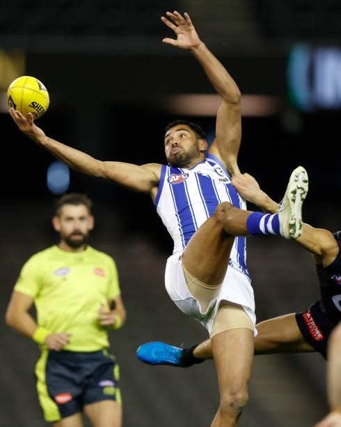Tarryn Thomas of the Kangaroos and Ed Curnow of the Blues in action during the 2021 AFL Round 19 match between the Carlton Blues and the North...