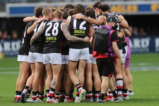 The Saints form a huddle during the 2021 AFL Round 19 match between the West Coast Eagles and the St Kilda Saints at Optus Stadium on July 24, 2021...
