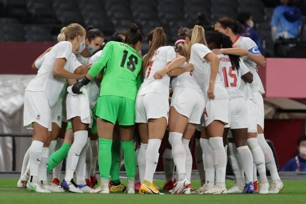Canada players gather in a huddle before the start of the Tokyo 2020 Olympic Games women's group E first round football match between Chile and...