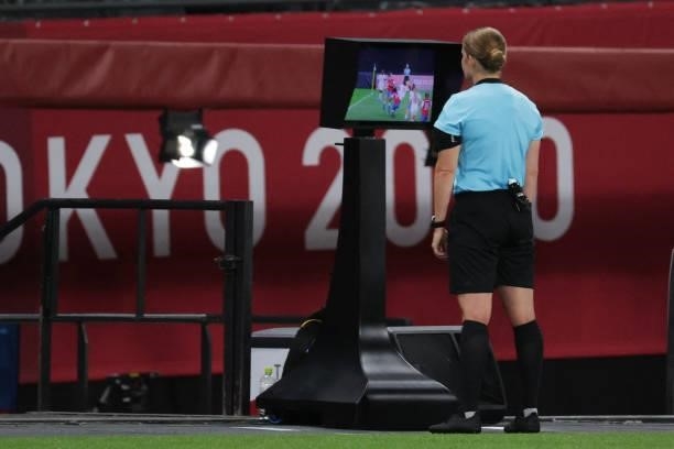 Swiss referree Esther Staubli checks the VAR during the Tokyo 2020 Olympic Games women's group E first round football match between Chile and Canada...