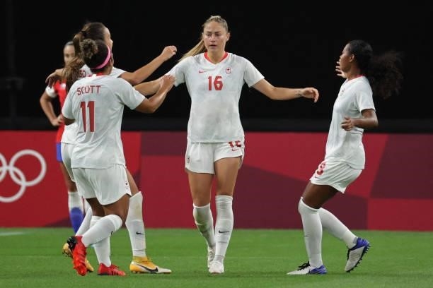 Canada's forward Janine Beckie celebrates with teammates after scoring her team's first goal during the Tokyo 2020 Olympic Games women's group E...