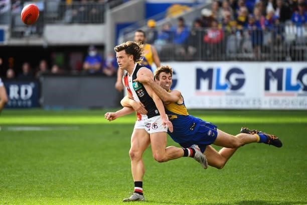 Jack Sinclair of the Saints handpasses the ball under pressure from Jamie Cripps of the Eagles during the 2021 AFL Round 19 match between the West...