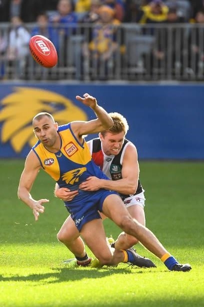 Dom Sheed of the Eagles is tackled by Sebastian Ross of the Saints during the 2021 AFL Round 19 match between the West Coast Eagles and the St Kilda...