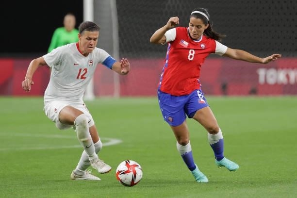 Chile's midfielder Karen Araya fights for the ball with Canada's forward Christine Sinclair during the Tokyo 2020 Olympic Games women's group E first...
