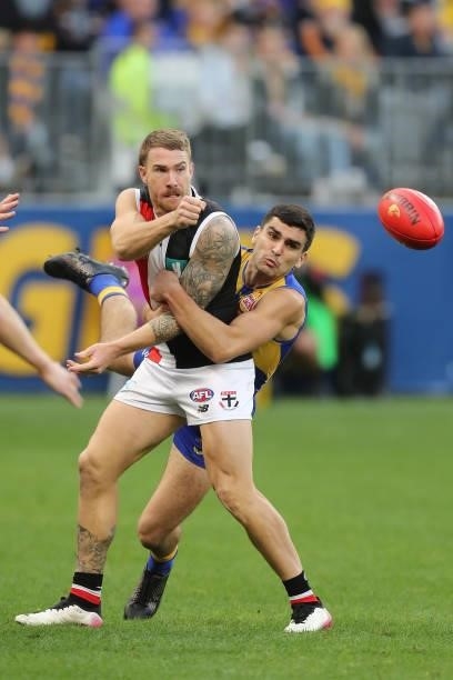 Tim Membrey of the Saints hand passes the ball under pressure from Tom Cole of the Eagles during the 2021 AFL Round 19 match between the West Coast...