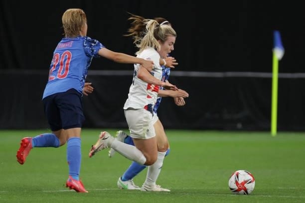 Japan's midfielder Honoka Hayashi fights for the ball with a Britain player during the Tokyo 2020 Olympic Games women's group E first round football...