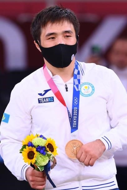 Bronze medallist Kazakhstan's Yeldos Smetov celebrates during the medal ceremony for the judo men's -60kg contest during the Tokyo 2020 Olympic Games...