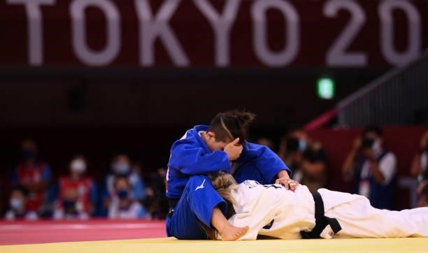 Kosovo's Distria Krasniqi and Japan's Funa Tonaki react during their judo women's -48kg final bout during the Tokyo 2020 Olympic Games at the Nippon...