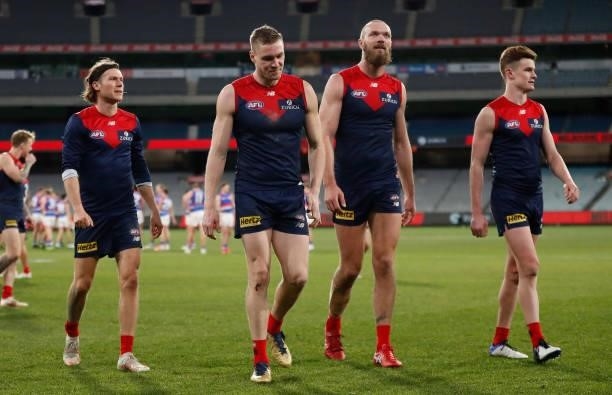 Ed Langdon, Tom McDonald, Max Gawn and Bayley Fritsch of the Demons look dejected after a loss during the 2021 AFL Round 19 match between the...