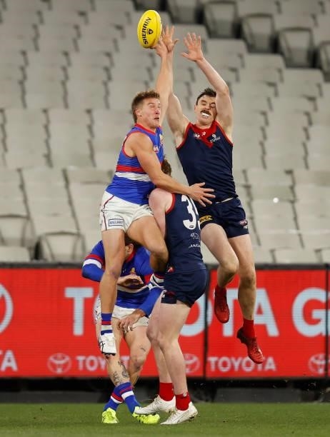 Roarke Smith of the Bulldogs and Jake Lever of the Demons compete for the ball during the 2021 AFL Round 19 match between the Melbourne Demons and...