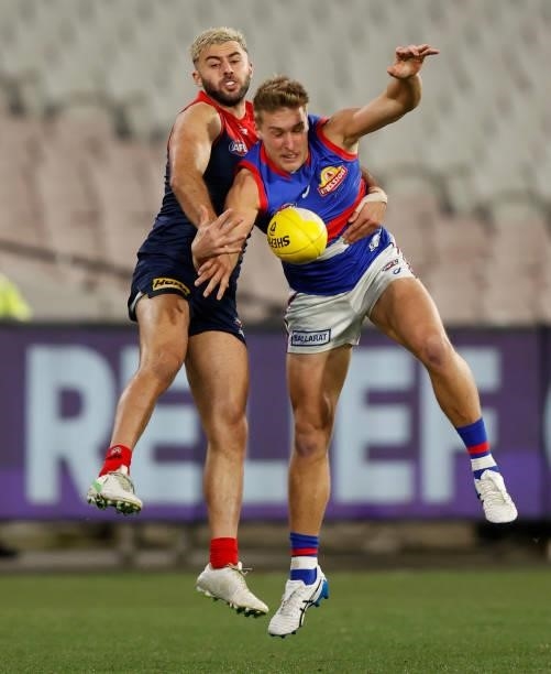 Roarke Smith of the Bulldogs and Christian Salem of the Demons compete for the ball during the 2021 AFL Round 19 match between the Melbourne Demons...