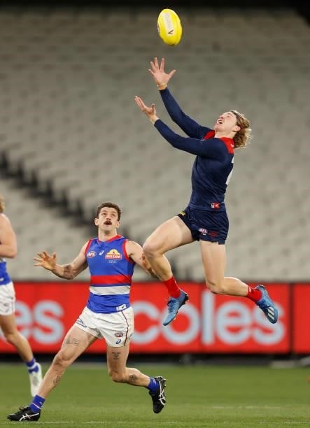 Jayden Hunt of the Demons and Tom Liberatore of the Bulldogs compete for the ball during the 2021 AFL Round 19 match between the Melbourne Demons and...
