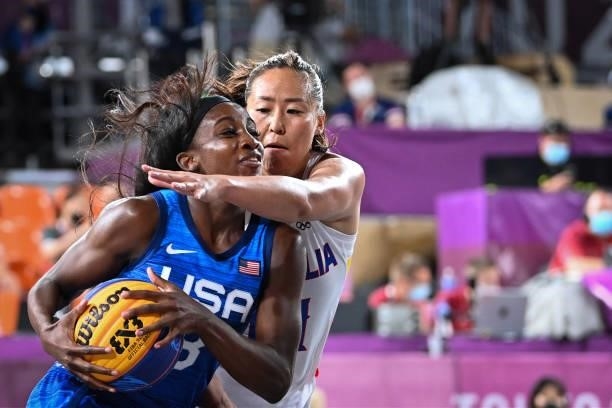 S Jacquelyn Young fights for the ball with Mongolia's Solongo Bayasgalan during the women's first round 3x3 basketball match between Mongolia and US...
