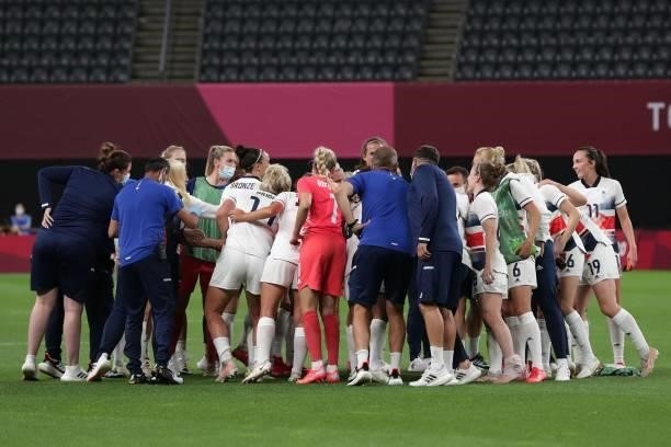 The Britain team gather in a huddle after they won the Tokyo 2020 Olympic Games women's group E first round football match between Japan and Britain...