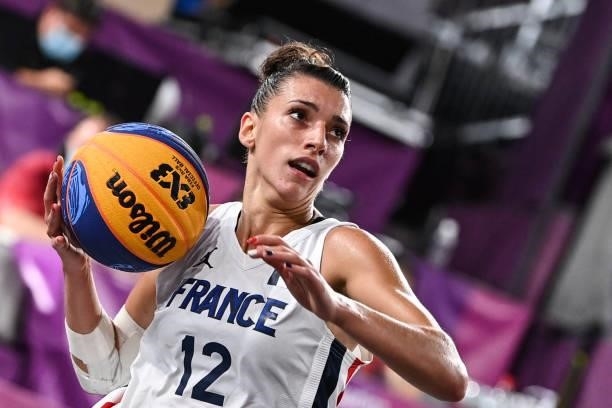 France's Laetitia Guapo controls the ball during the women's first round 3x3 basketball match between France and Italy at the Aomi Urban Sports Park...