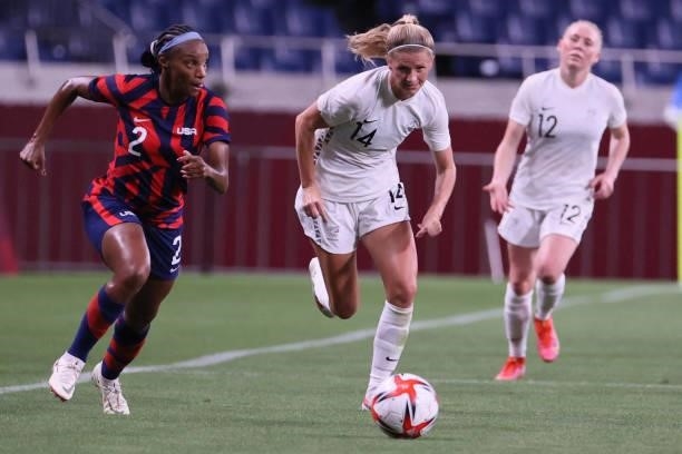 New Zealand's midfielder Katie Bowen vies for the ball with USA's defender Crystal Dunn during the Tokyo 2020 Olympic Games women's group G first...