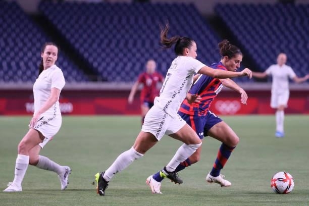 S forward Carli Lloyd dribbles past New Zealand's defender Ali Riley during the Tokyo 2020 Olympic Games women's group G first round football match...