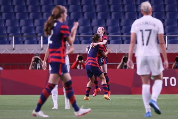 S midfielder Rose Lavelle celebrates with USA's forward Tobin Heath after scoring the opening goal during the Tokyo 2020 Olympic Games women's group...