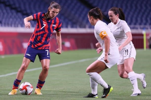 S forward Tobin Heath is marked by New Zealand's defender Ali Riley and New Zealand's midfielder Olivia Chance during the Tokyo 2020 Olympic Games...