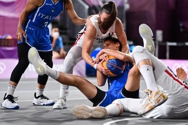 Italy's Chiara Consolini fights for the ball with France's Marie-Eve Paget and France's Ana Maria Filip during the women's first round 3x3 basketball...
